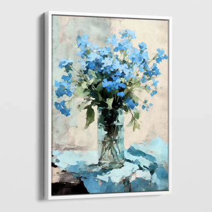 Framed watercolor painting of a bouquet of blue forget-me-not flowers arranged in a clear glass vase. The vase sits on a soft blue cloth, with a neutral background, evoking an impressionist style. The white frame adds a modern touch to the artwork.