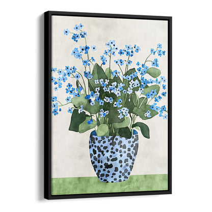Canvas print with a black frame, featuring a watercolor-style depiction of blue forget-me-not flowers with green leaves, arranged in a patterned blue vase, set against a soft neutral background with a green surface.