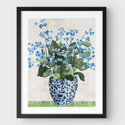 Artwork with a black frame and white border, featuring a watercolor-style depiction of blue forget-me-not flowers in a patterned blue vase, set against a soft neutral background and a green surface.