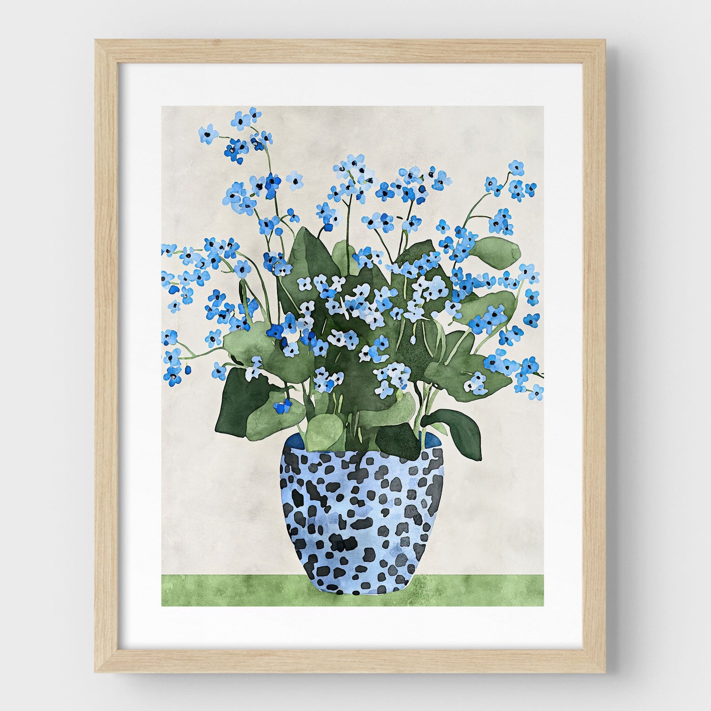 Artwork with a natural wood frame and white border, featuring a watercolor-style depiction of blue forget-me-not flowers in a patterned blue vase, set against a soft neutral background and a green surface.