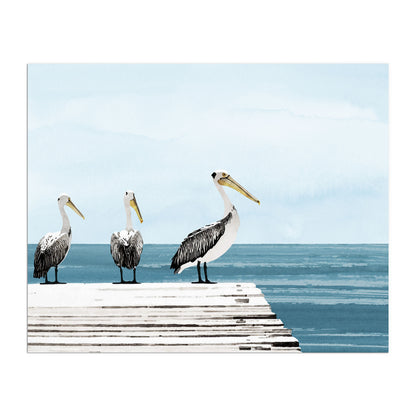 Watercolor-style illustration of three pelicans standing on a white wooden dock extending over calm blue ocean water, with a pale sky and soft clouds in the background.