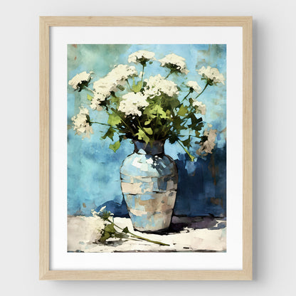 Framed watercolor painting of Queen Anne's Lace flowers in a blue and white ceramic vase. The delicate white blooms contrast with the vibrant blue background. A natural wood frame and white border enhance the impressionist style, creating an elegant and serene composition.