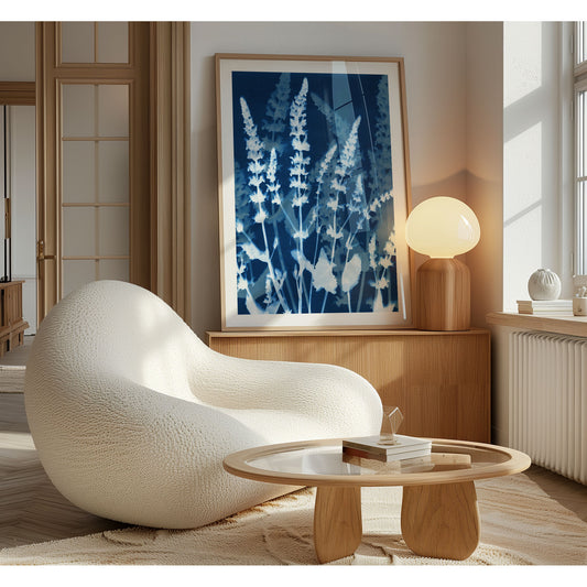 Cyanotype-style print of salvia stems framed and displayed in a cozy, modern room with soft lighting, light wood furniture, and neutral tones, blending vintage botanical aesthetics with minimalist interior design.