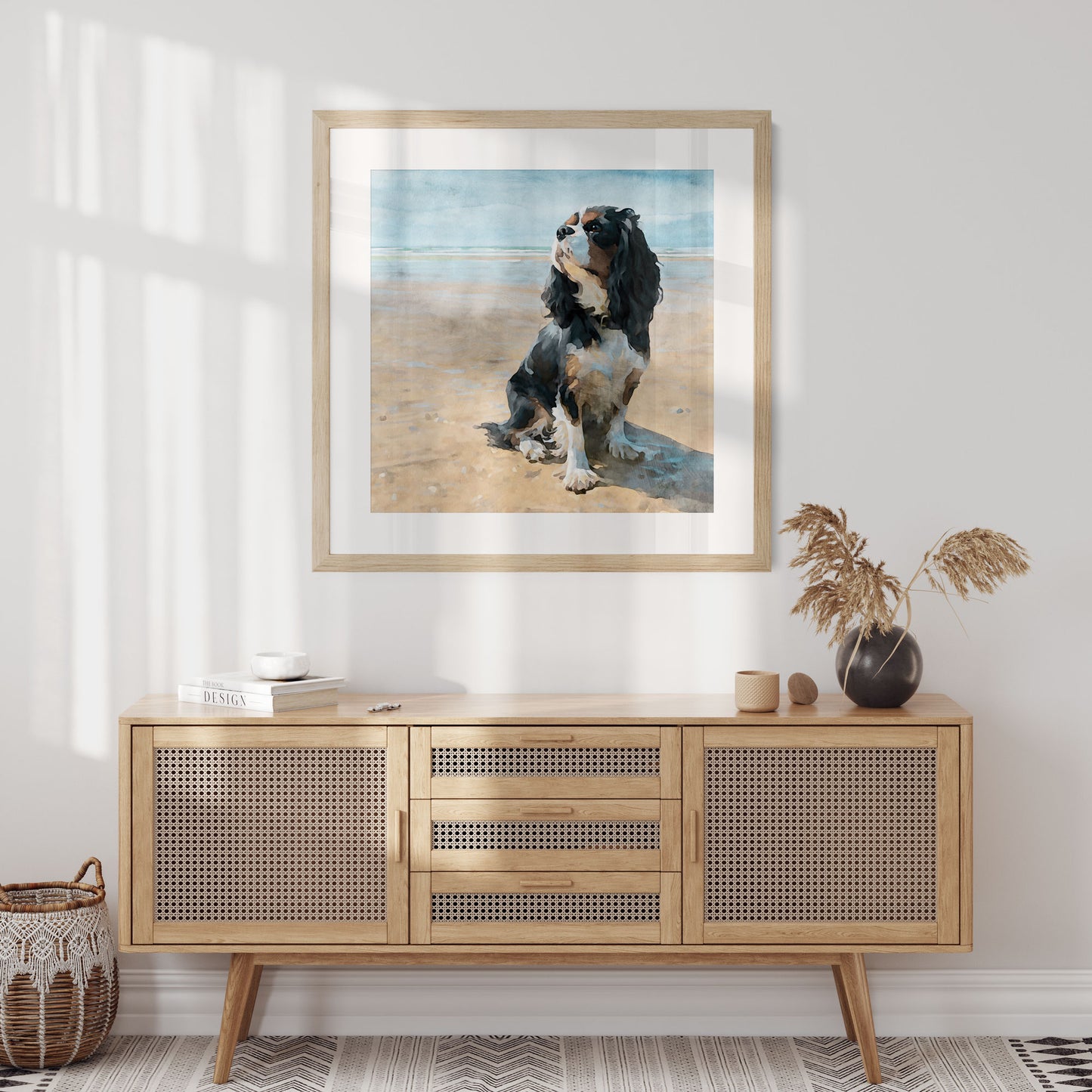 Wooden sideboard with decorative items and a framed picture of a dog on a beach.