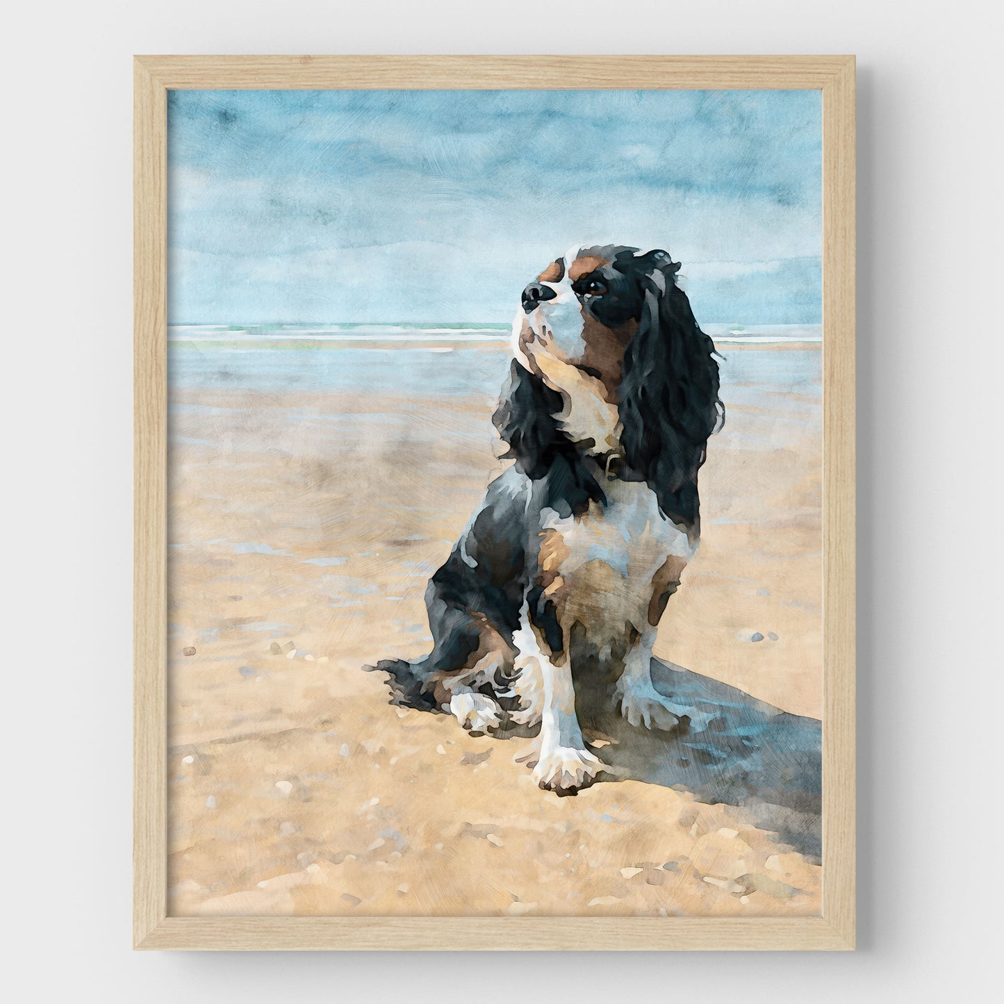 Natural wood framed artwork of a tricolor King Charles spaniel on a beach