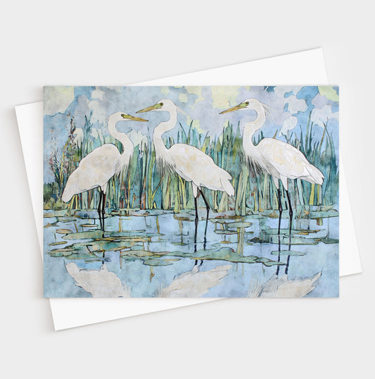 Greeting card with watercolor illustration of three white egrets by a pond