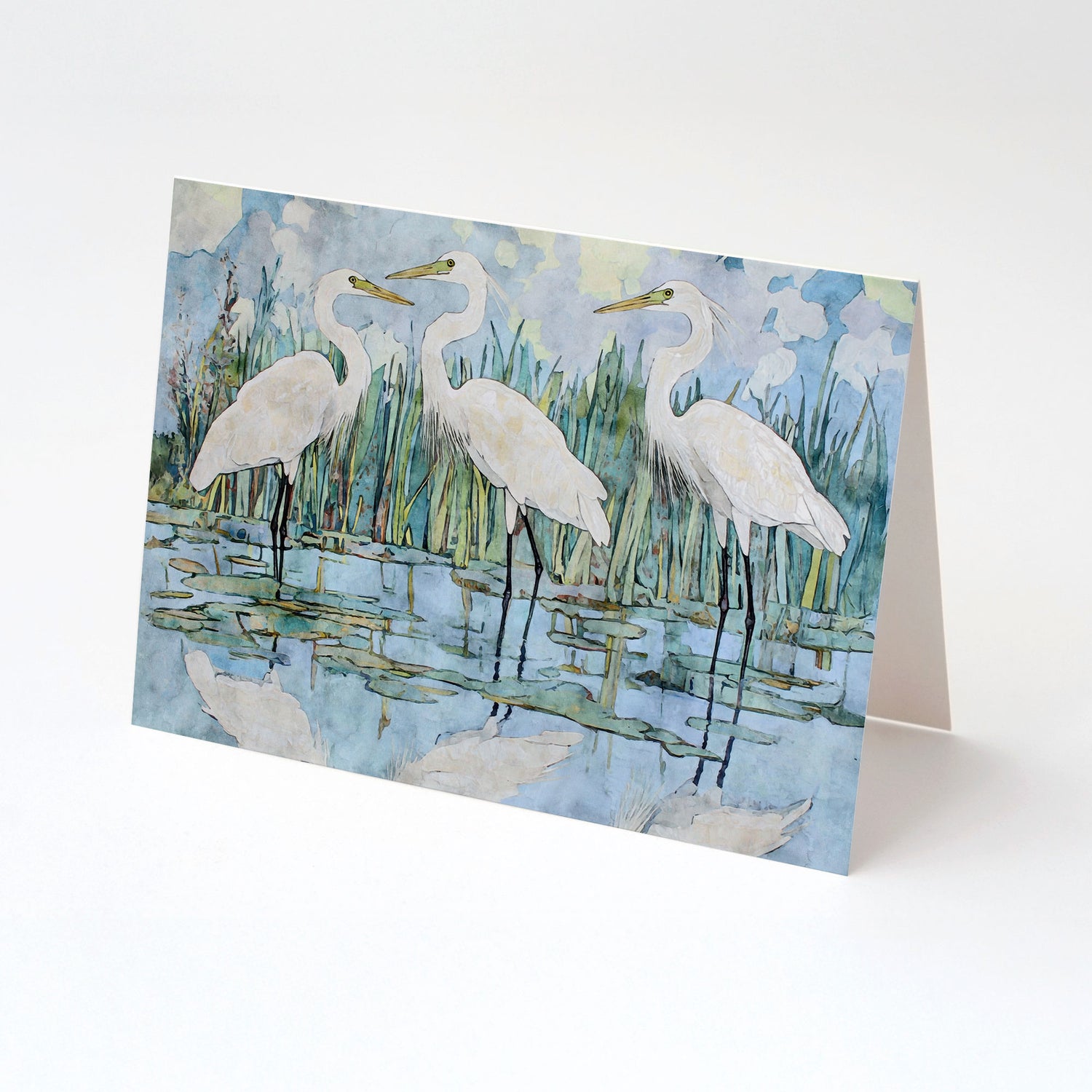 Greeting card with a painting of three white birds on a blue water background