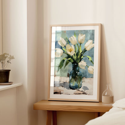 Interior setting with a large framed watercolor painting of white tulips in a blue vase, displayed on a wooden console table next to a small vase and dried flowers.