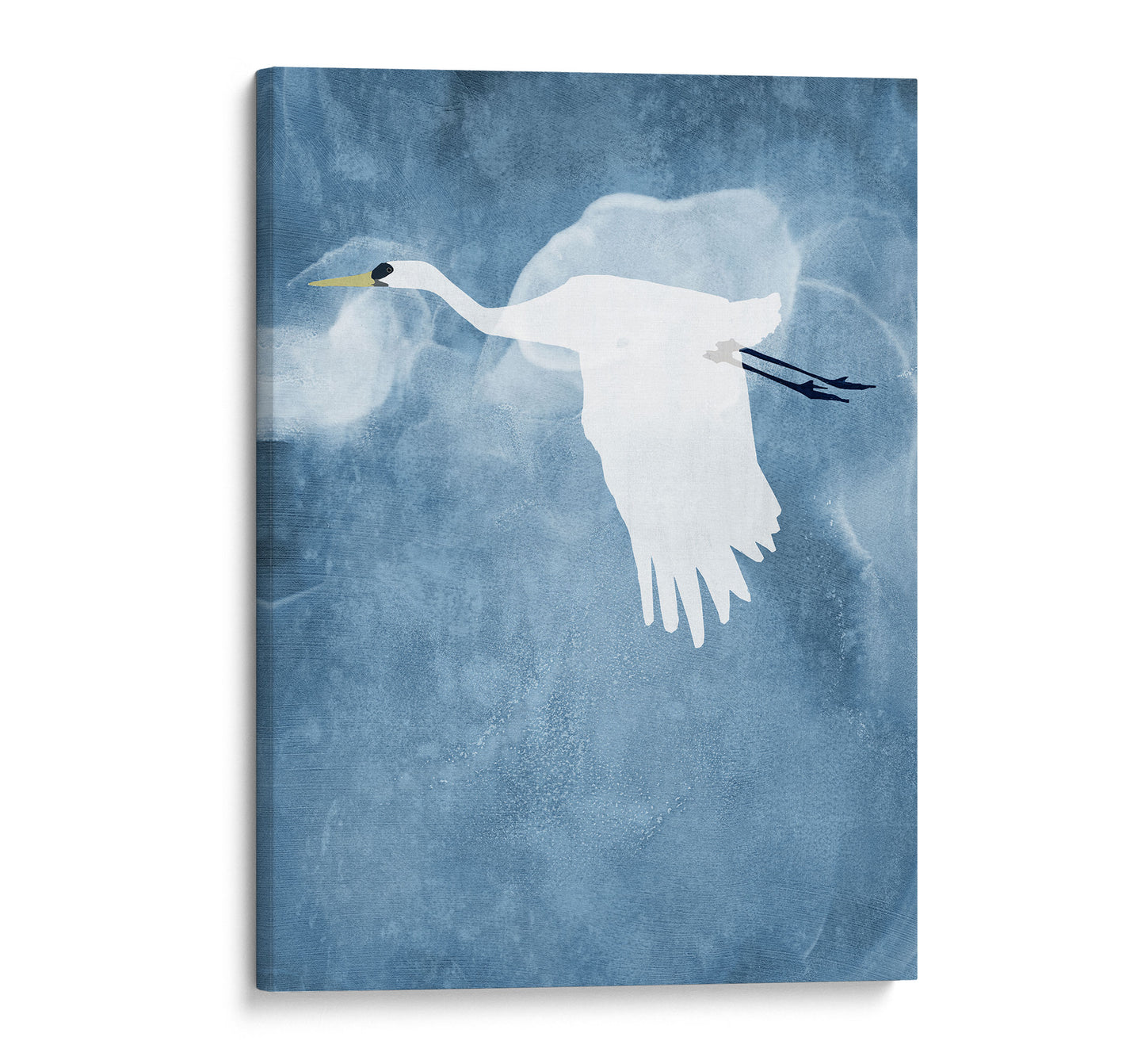 Minimalist canvas print of a white heron flying with wings lowered against a textured blue background with soft, swirling cloud-like shapes.