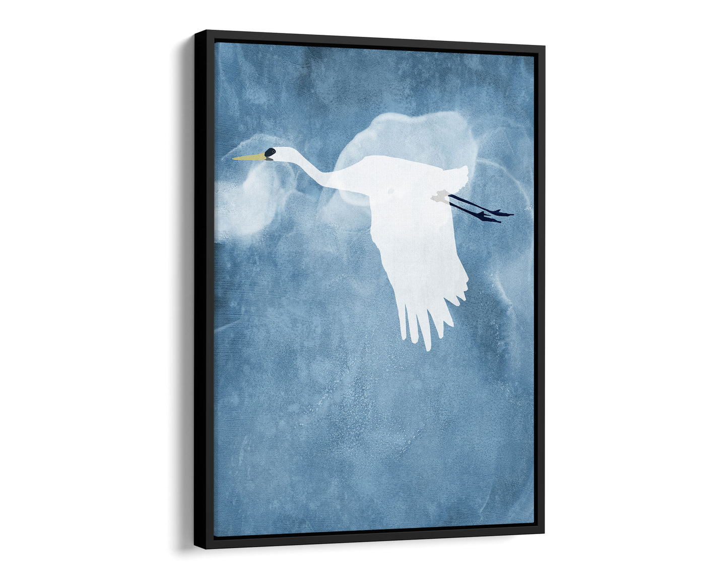 Black framed canvas print of a white heron in flight with wings lowered, set against a textured blue background with soft cloud-like swirls.