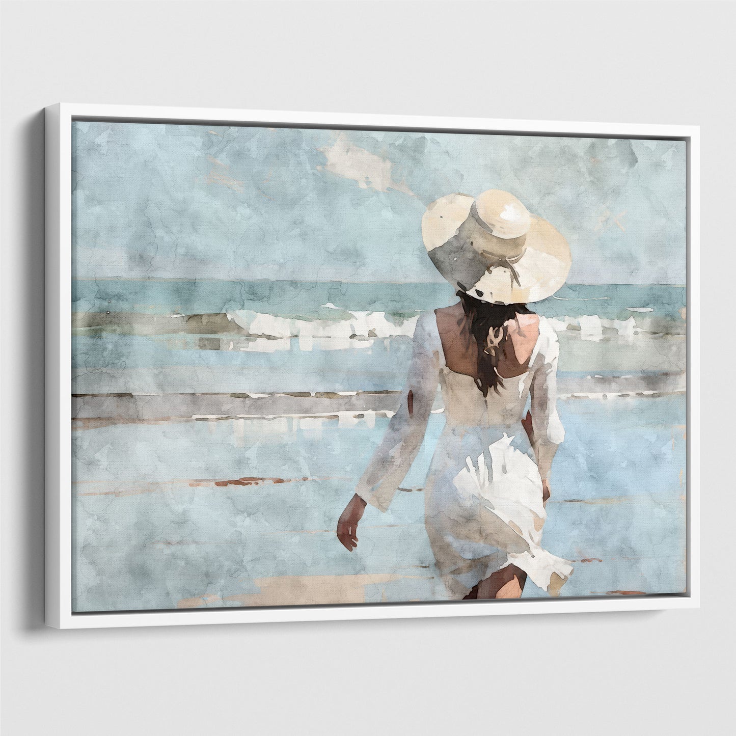 Watercolor painting of a woman in a white dress and wide-brimmed hat walking toward the ocean on a sandy beach, with waves in the background.  Artwork printed on gallery wrap canvas in white floater frame.