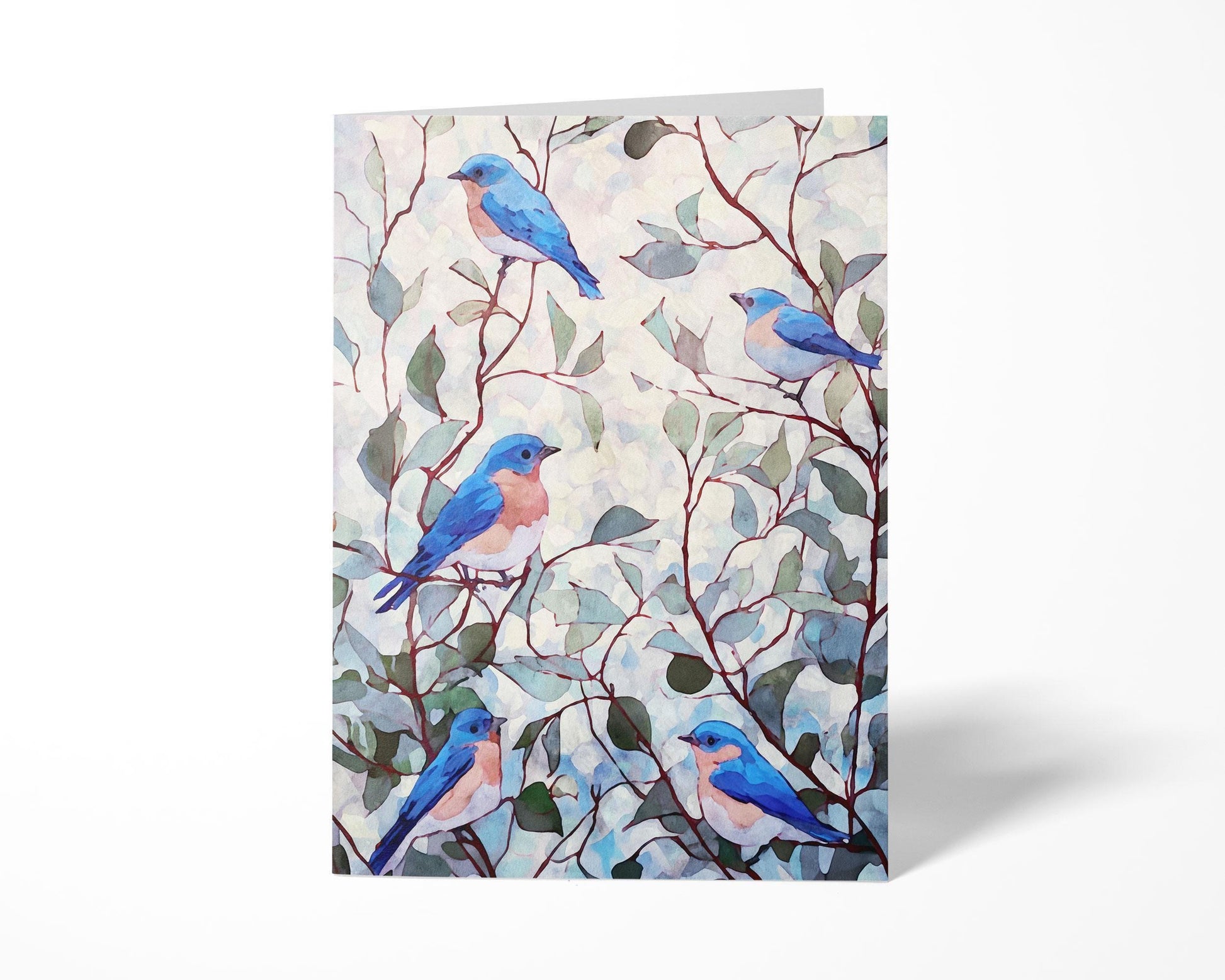 Folded greeting card featuring a watercolor illustration of five bluebirds with peachy chests perched among slender brown branches and soft green leaves against a pale, textured background.