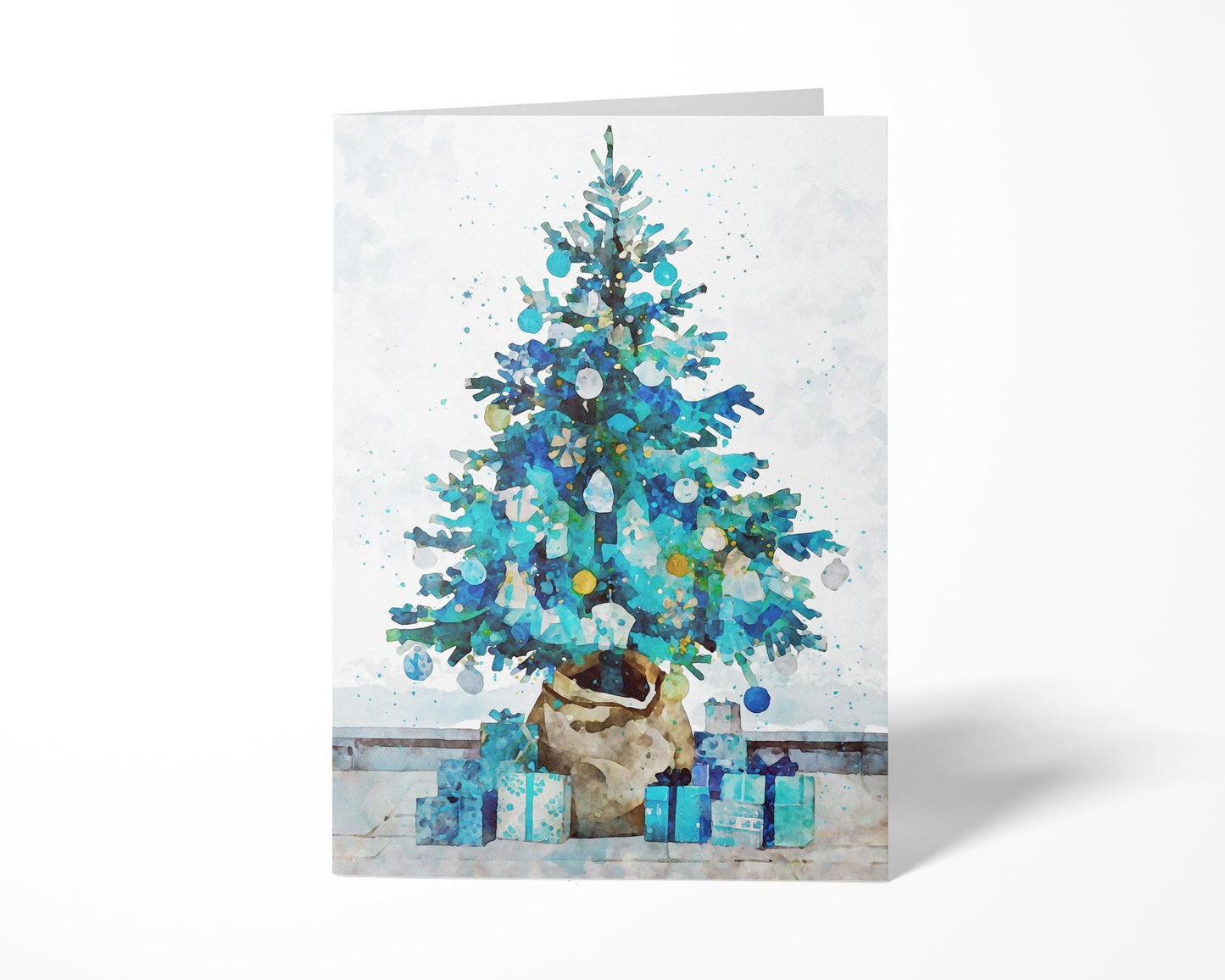 Folded Christmas card featuring a watercolor-style blue and teal tree decorated with ornaments, set in a burlap-wrapped pot with matching blue presents at its base against a soft white background.