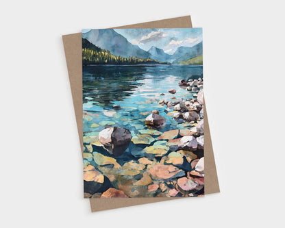 Watercolor-style illustration of a serene mountain lake with crystal-clear water, smooth rocks in the foreground, forested shoreline, and blue mountains under a partly cloudy sky in the background.