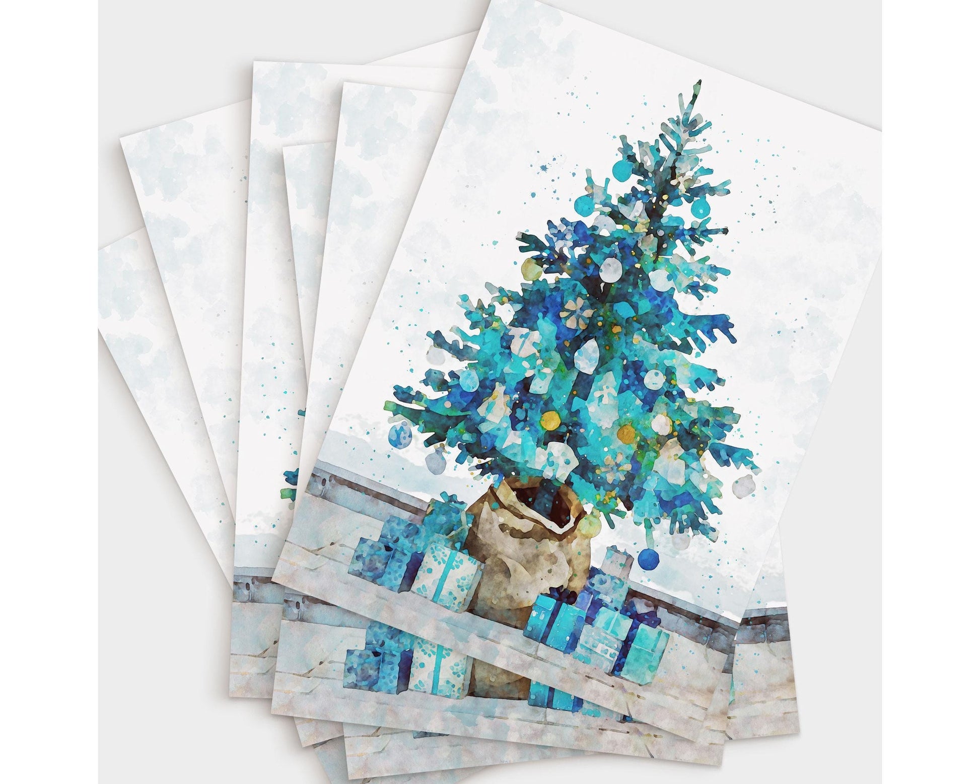 Set of holiday cards featuring a watercolor-style Christmas tree in shades of blue and teal, decorated with ornaments and surrounded by matching presents in a burlap pot on a light background.