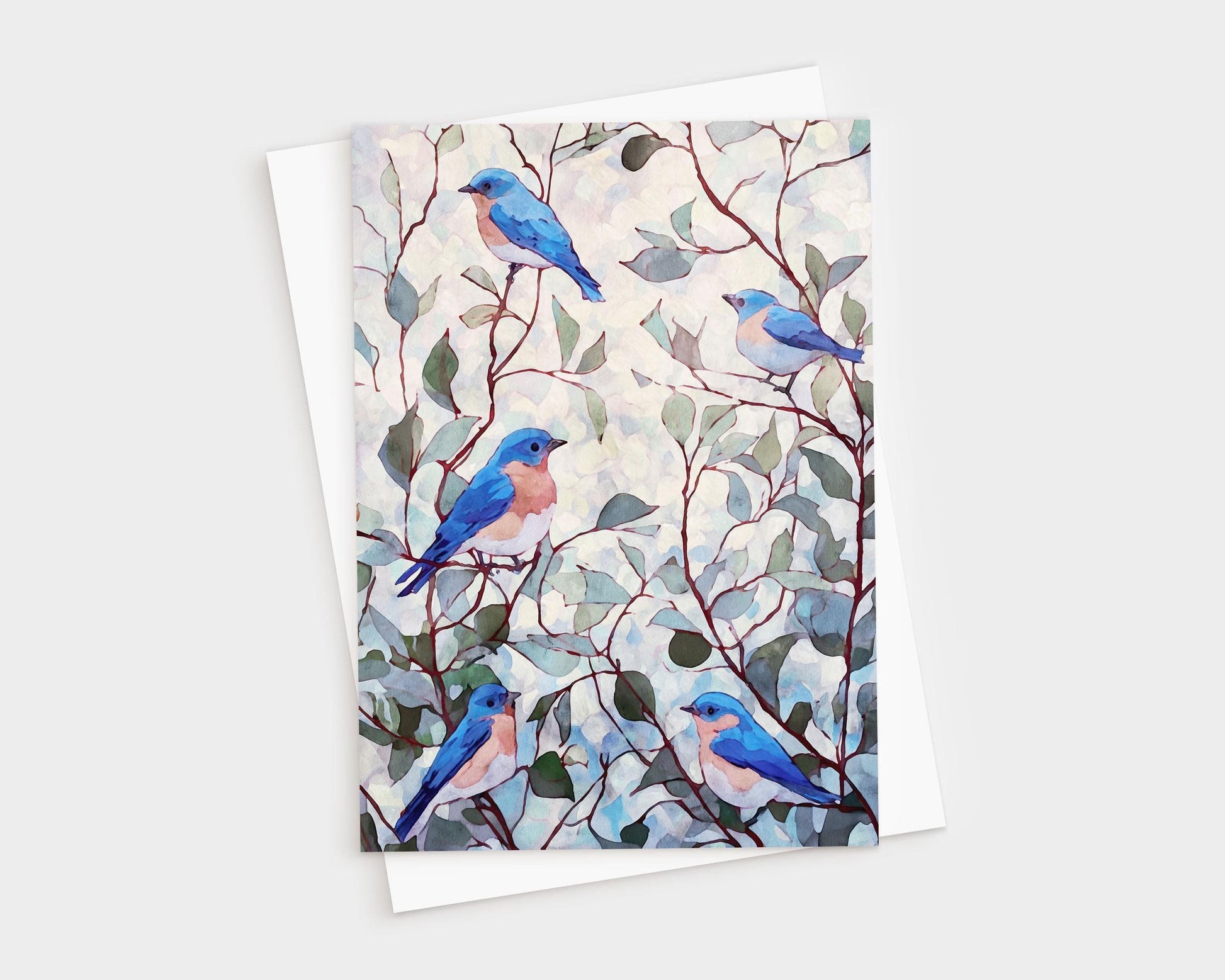 Watercolor greeting card featuring five bluebirds with peachy chests perched among delicate branches and muted green leaves against a softly dappled background, paired with a white envelope.